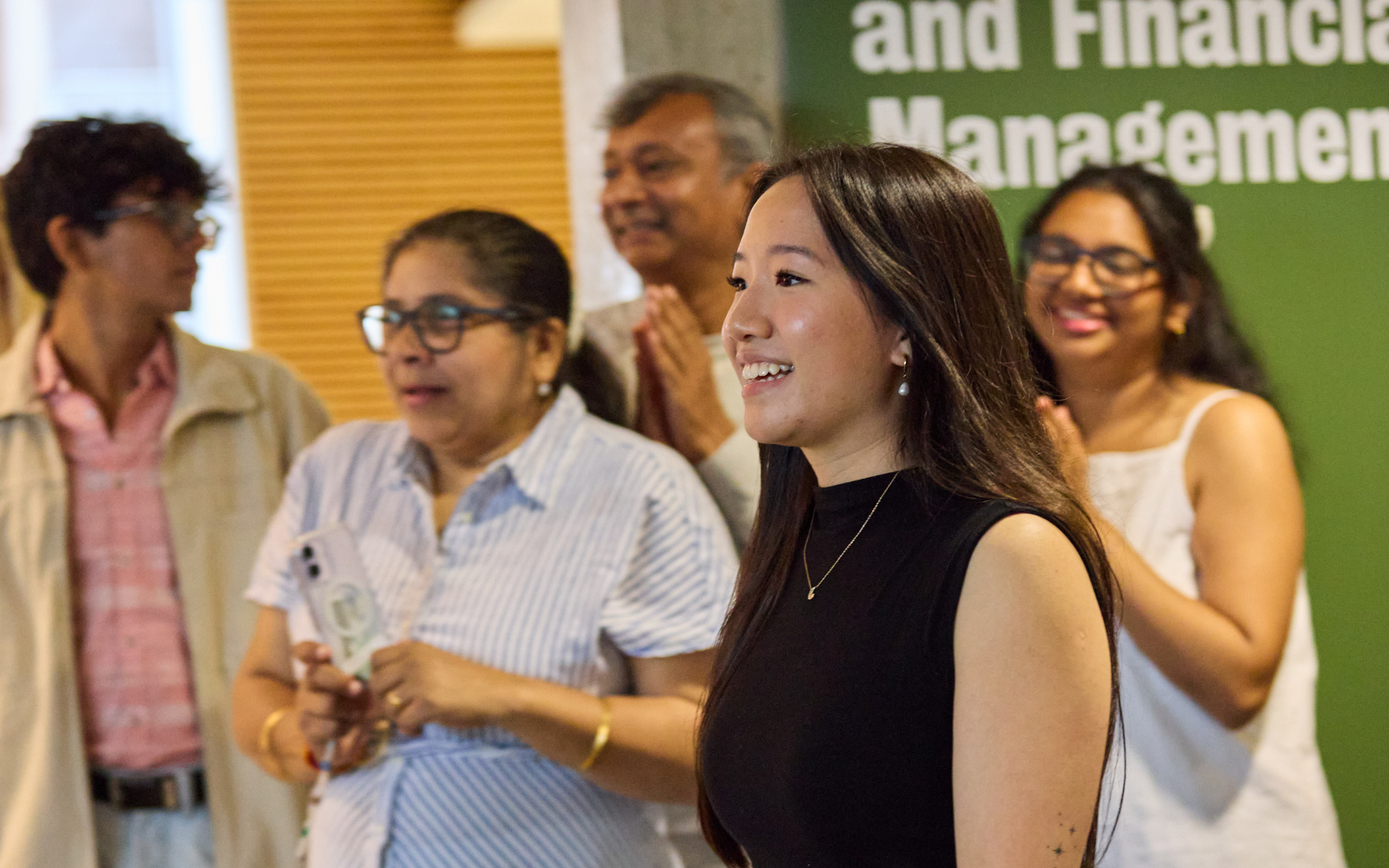 SFM graduates watch a presentation at the special reception.