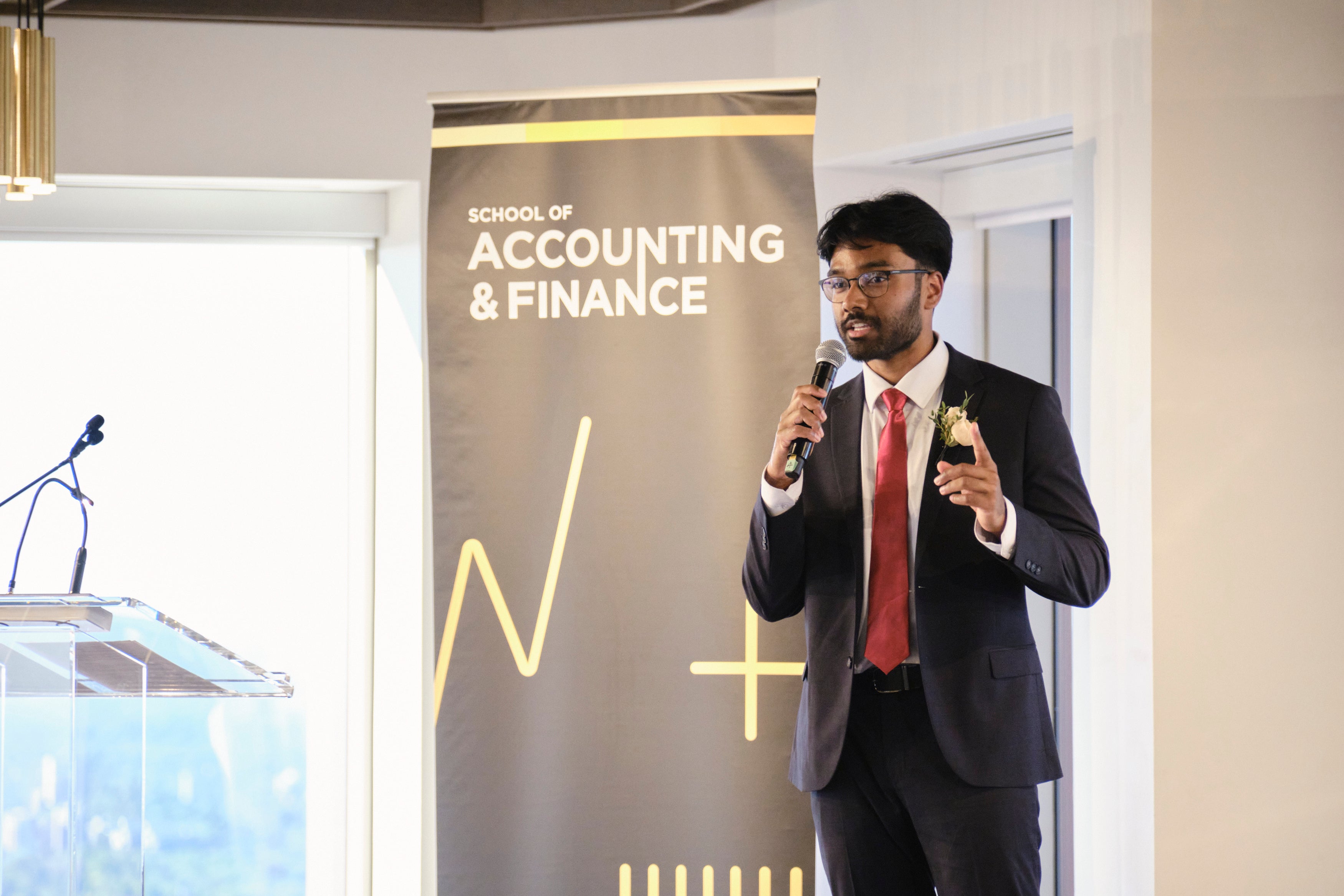 CFA Research Challenge team caption, SAF student Jei Raman Gnaneswaran takes the stage at the gala