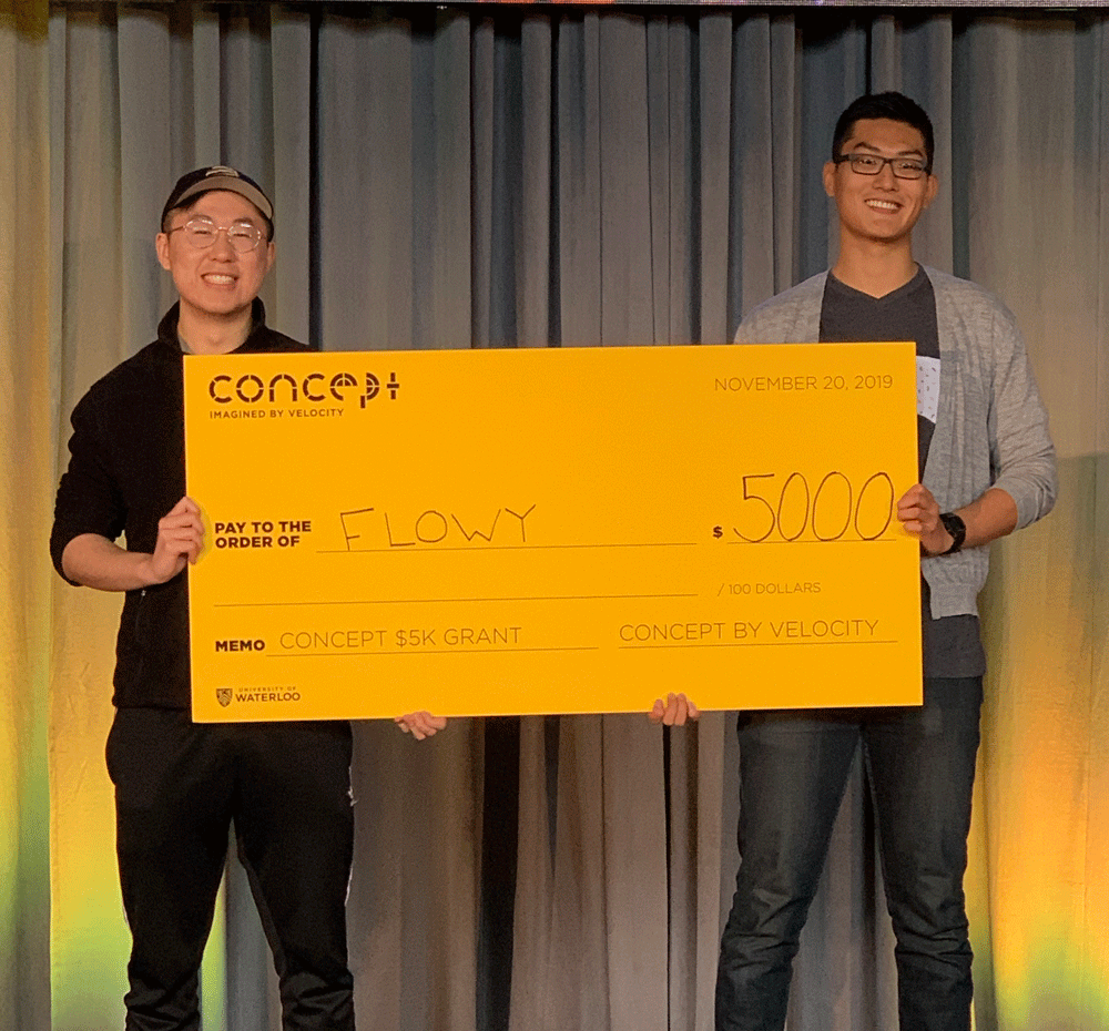 Neil Liu and David Zhao hold a cheque