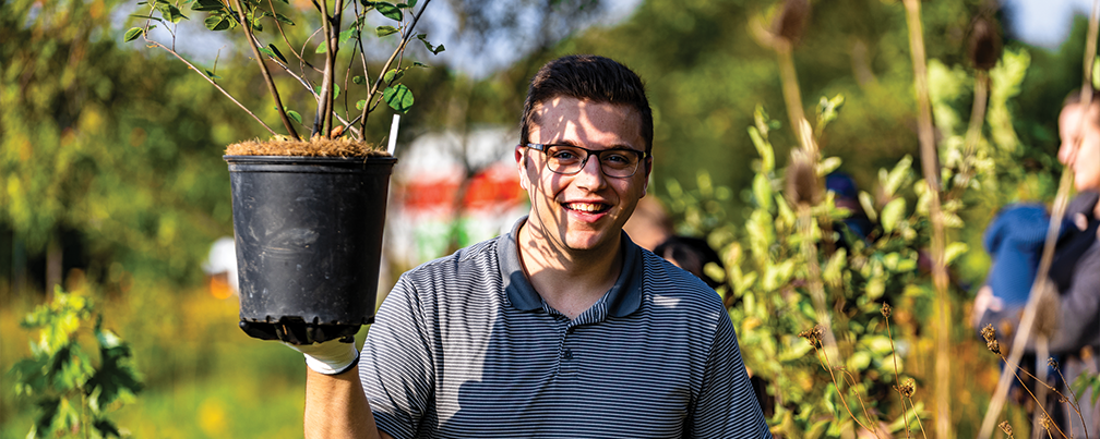 Ethan holding a plant