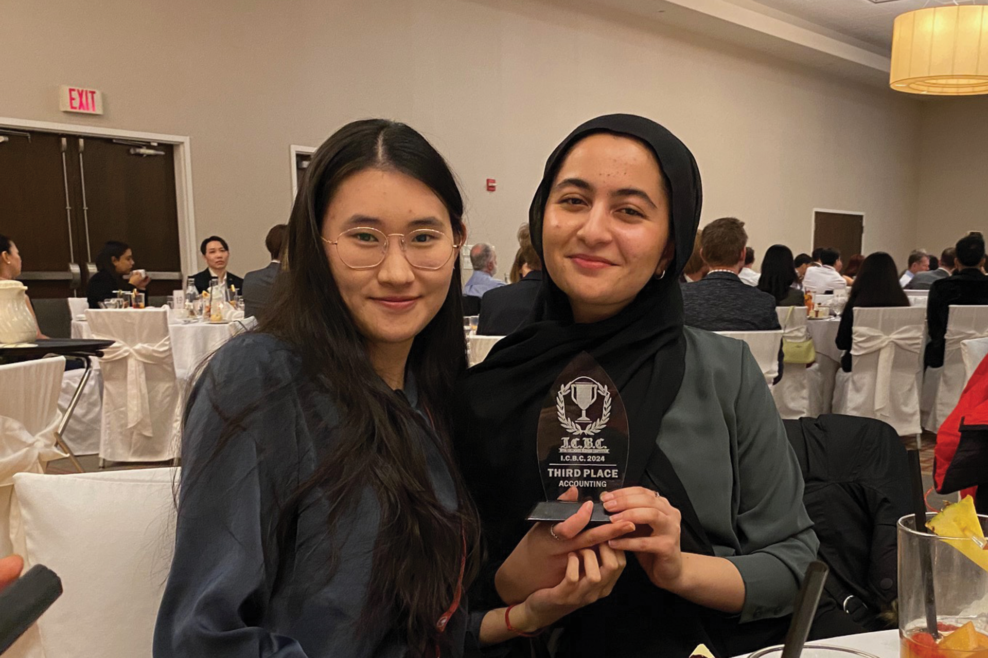 Joanna and Hufsah with a trophy they won