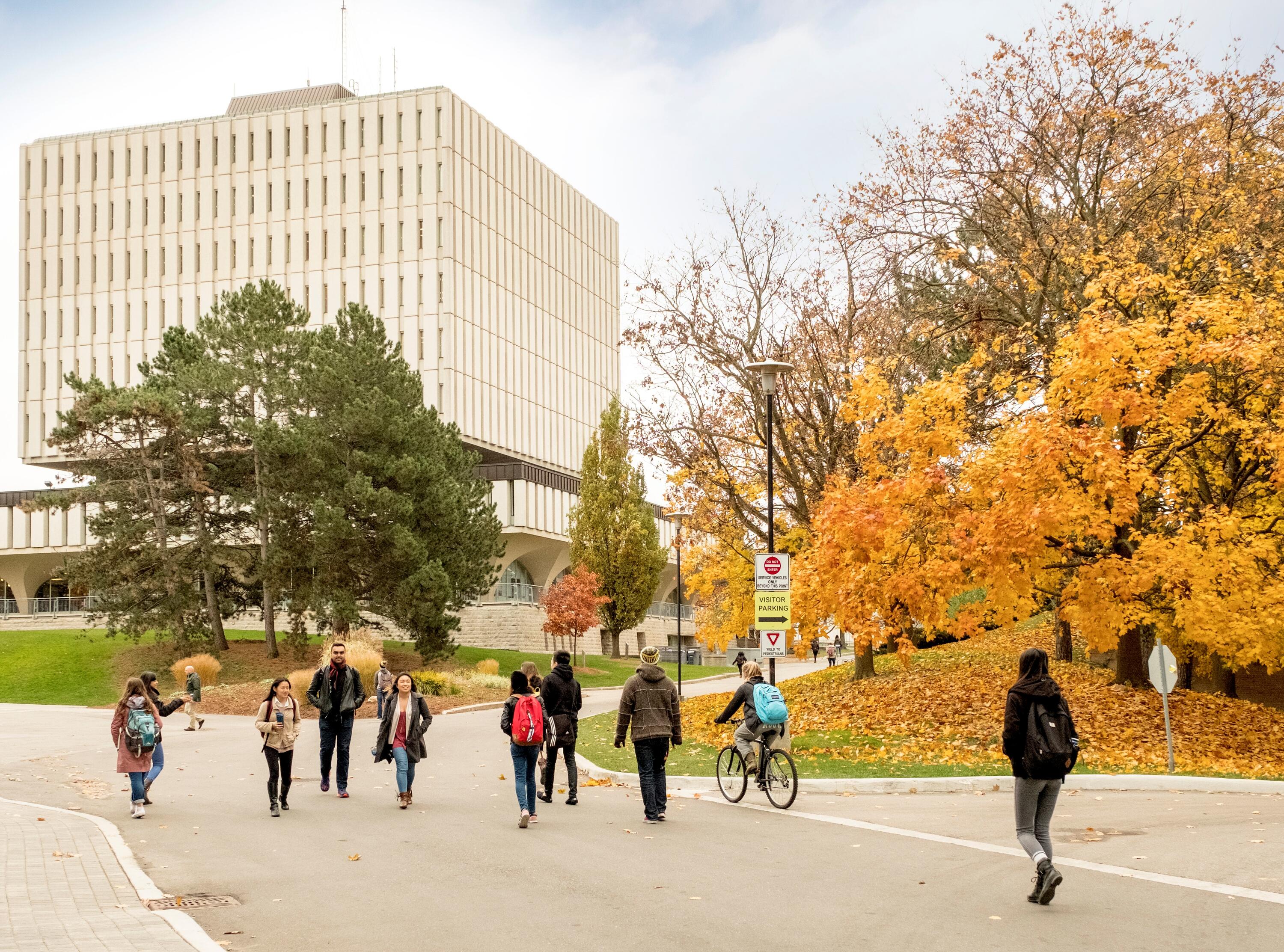 Students walking in front of Dana Porter Library