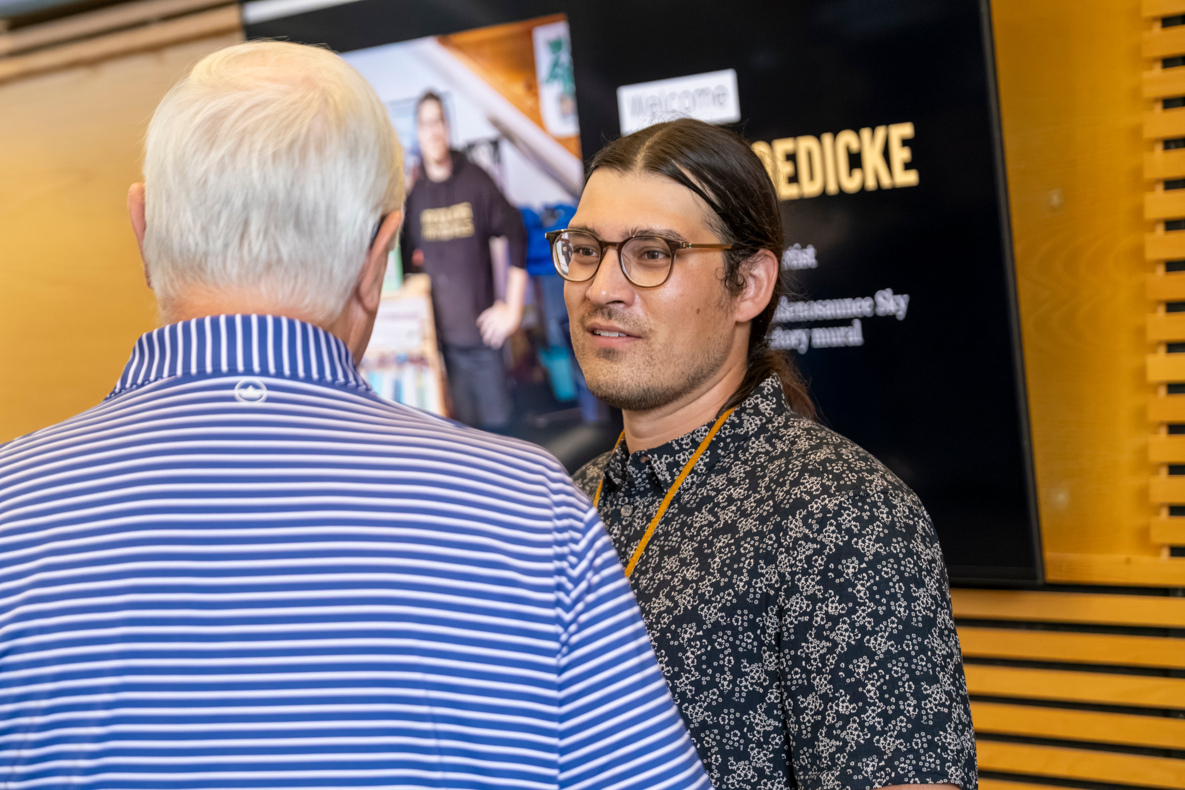 Artist Kyle Joedicke mingles with guests during the Art Unveiling