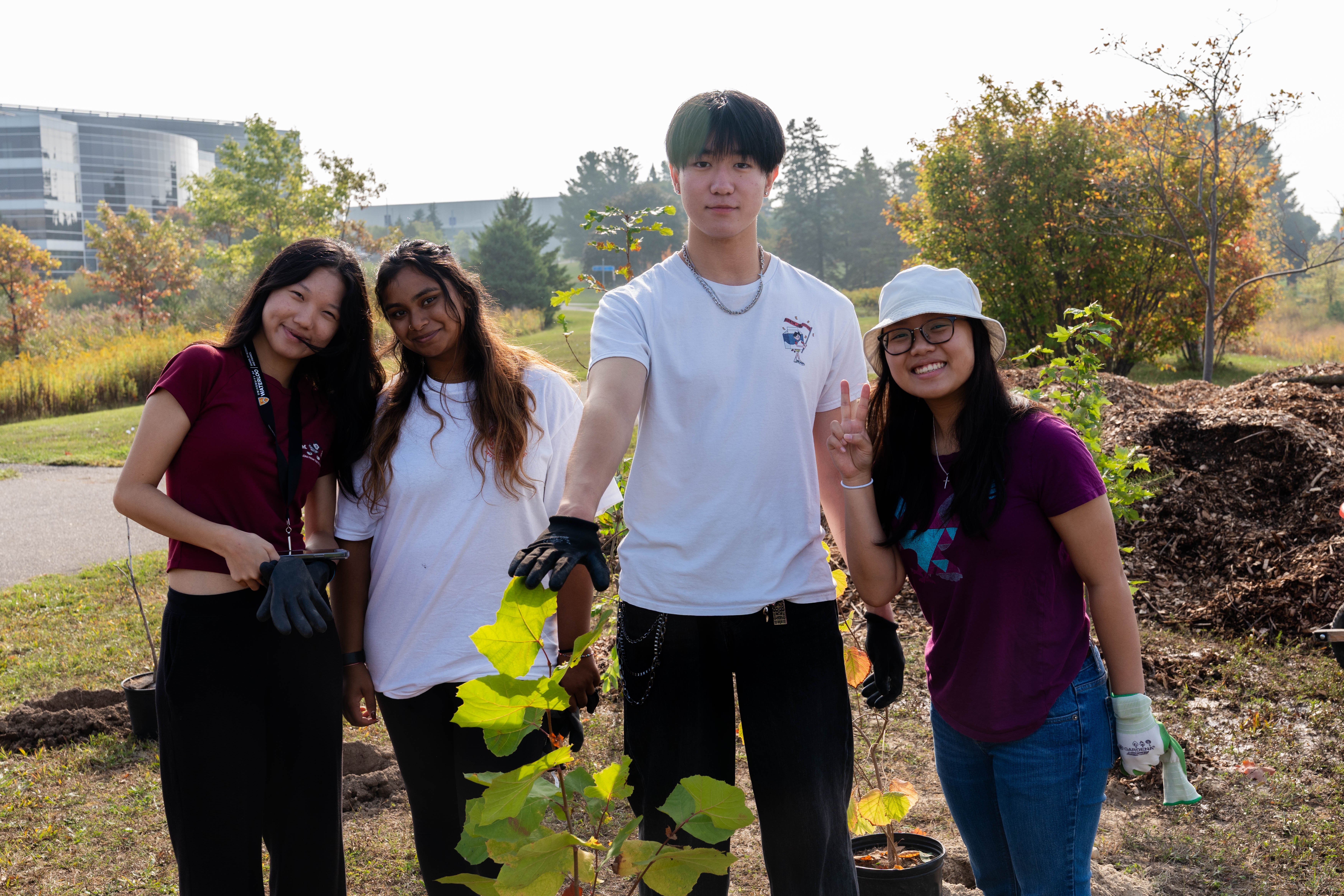 Four SFM students pose for a photo at the SFM tree planting event