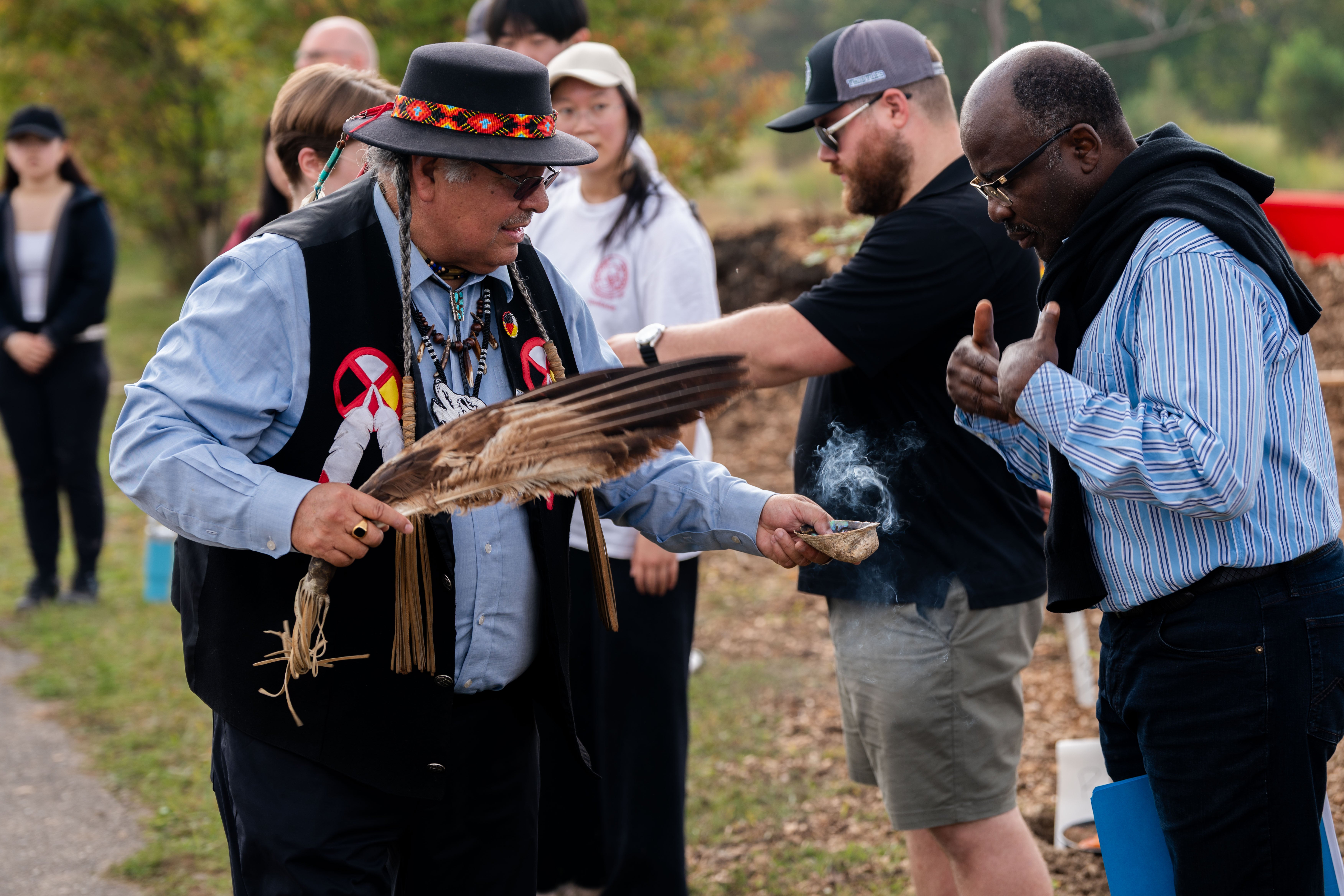 Elder Henry conducts a smudge ceremony at the SFM tree planting event.