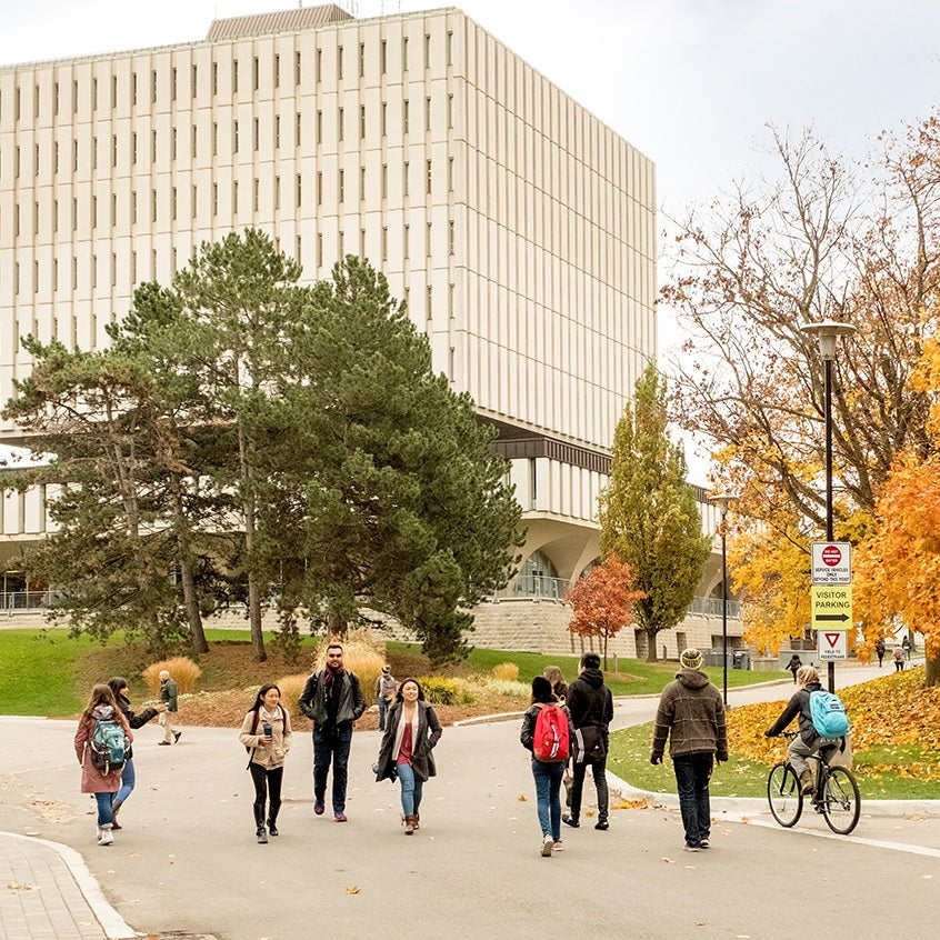 Students walking in front of library