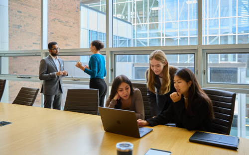 SAF students discussing at a table
