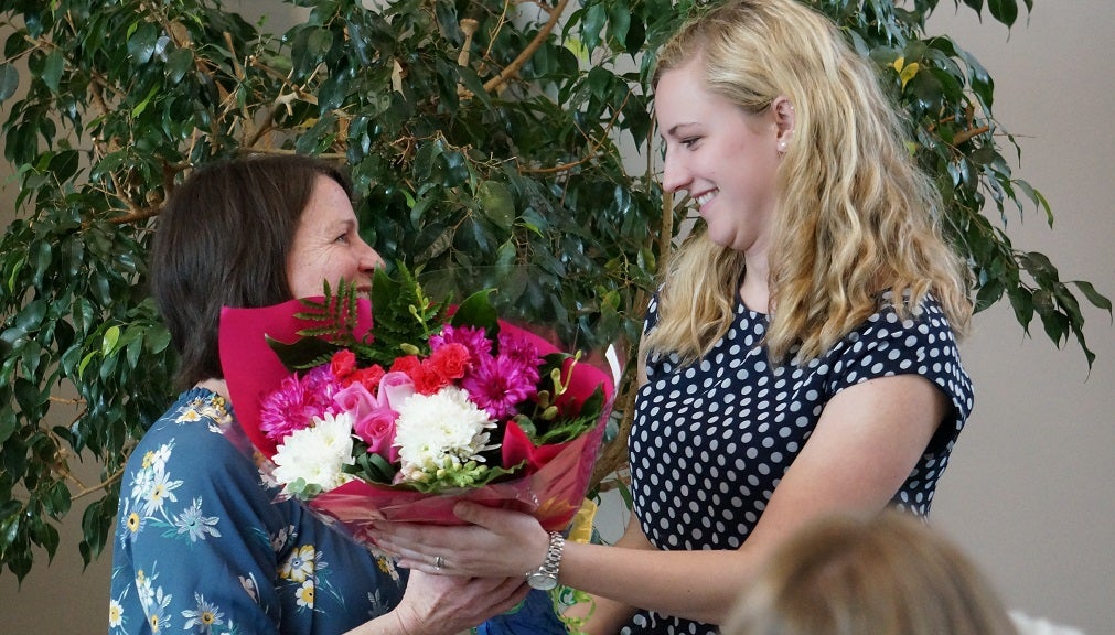 field instructor receiving flowers from a student