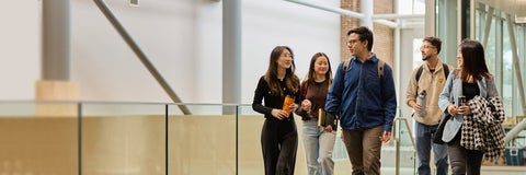 A group of students walks through Hagey Hall