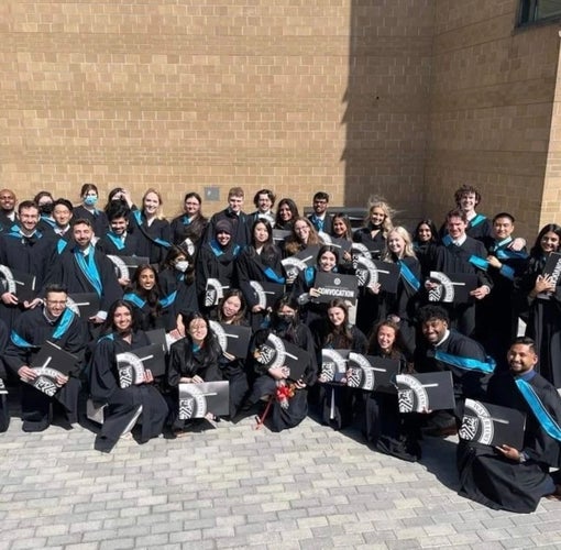 Scibus graduates posing outside SLC