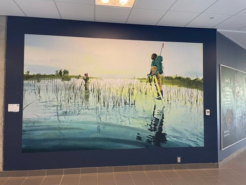 An Amanda Rhodenizer painting of two scientists taking samples in a wetland.