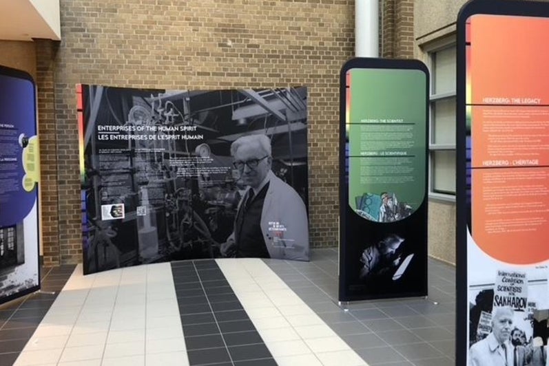 Information kiosks on the Herzberg exhibit in front of a brown brick wall.