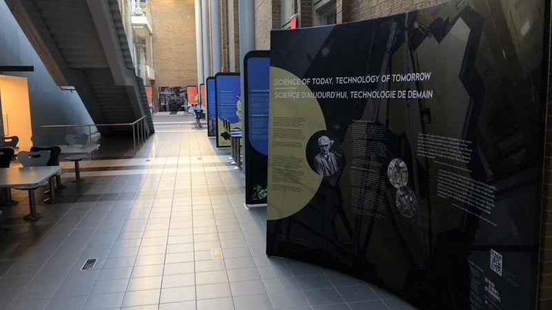 Information kiosks on the Herzberg exhibit set up in a hallway.
