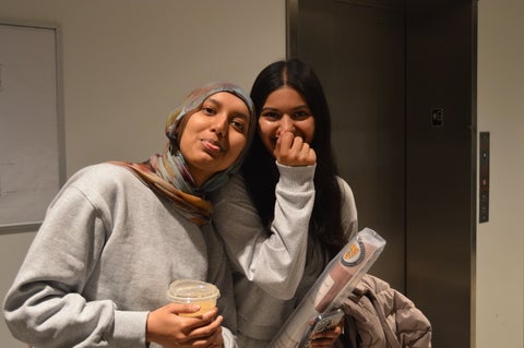 Two people posing with each other