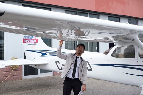Student completing pre-flight check on small aircraft