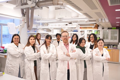 Instructor and students in lab coats