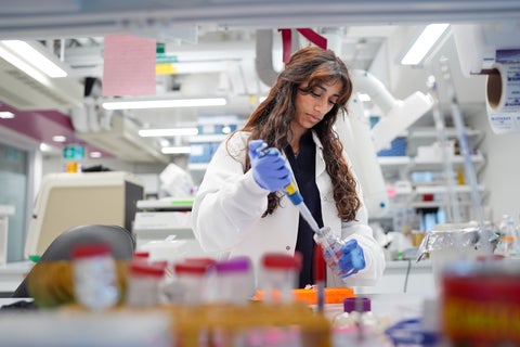 scientist in lab with pipette 