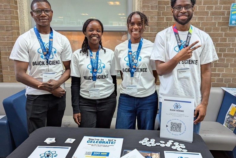 4 Black Science students set up at an information table