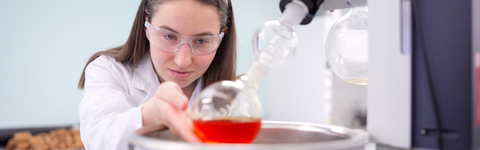 a science student performing an experiment in a chemistry lab