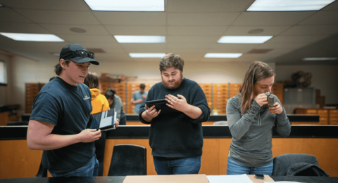 Three students analyzing mineral deposits.