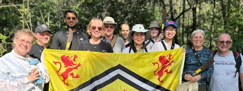 A group of alumni in Costa Rica holding the UWaterloo flag
