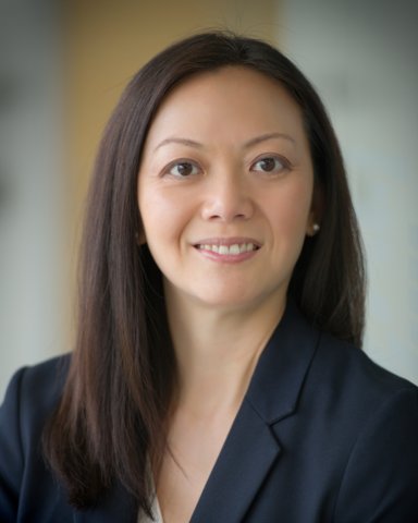 A headshot of Lisa. She is wearing a black blazer and white shirt.