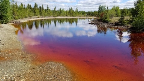 Mine tailings pond coloured bright orange.