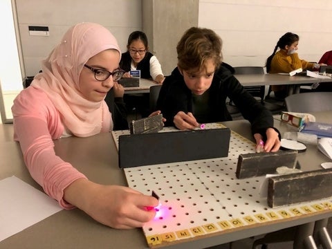 two students line up lasers