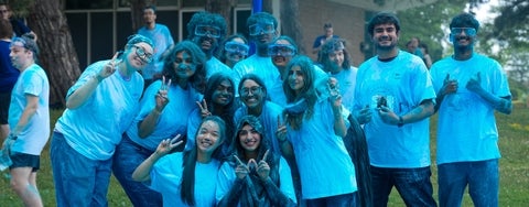 Students covered in blue powder on Science Day.