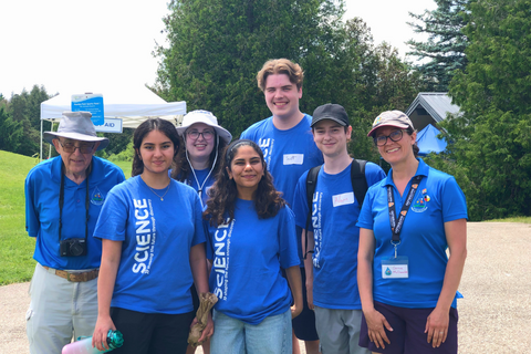 Five students and two staff volunteers wearing Science blue t-shirts at the children's groundwater festival.