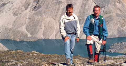Stephen Evans and his colleague standing in front of Avalanche Lake Rock.