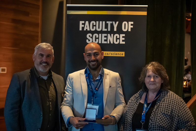 Science graduate student being presented a medal