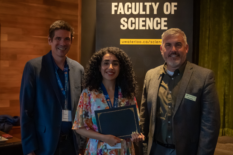 Science graduate student being presented an award