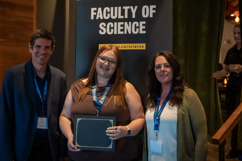 Science graduate student being presented an award
