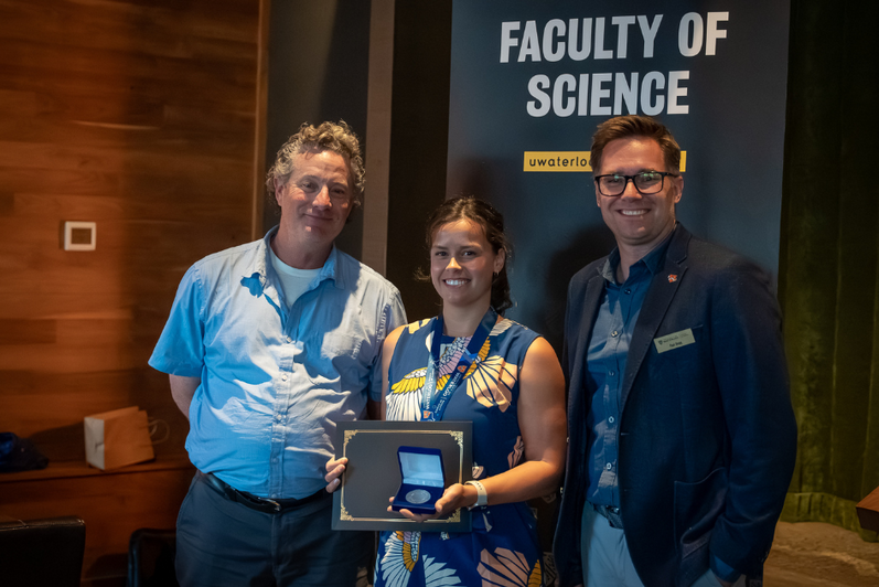 Science graduate student being presented an award