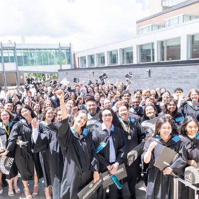 Science graduates grouped together outside following the convocation ceremony