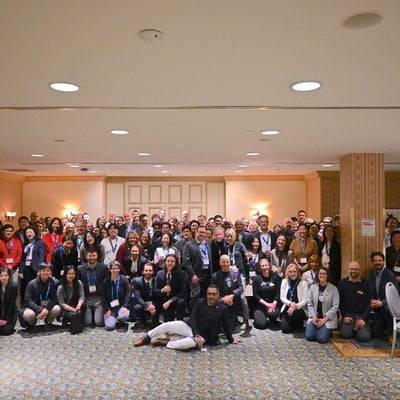 A group of around 100 people at the PDAC alumni event