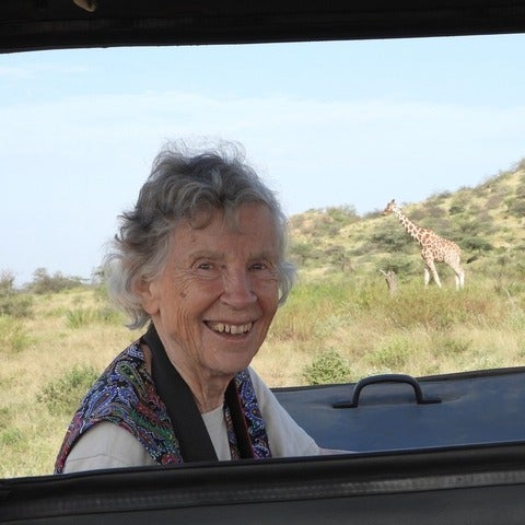 Anne in Kenya with a giraffe in the background