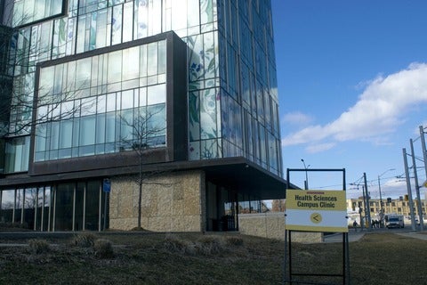 School of Pharmacy building with sign in front saying "Health Sciences Clinic"