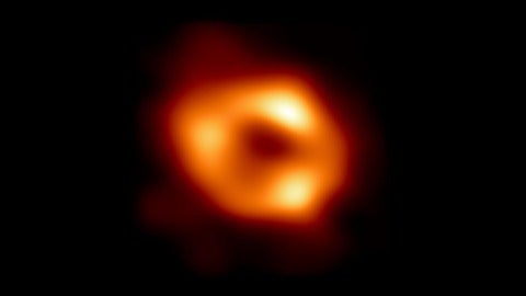 A bright orange ring with three very bright spots almost equally spaced along the ring