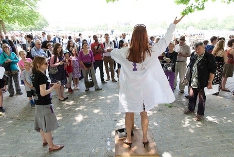 Scientist speaking to a crowd from a soapbox