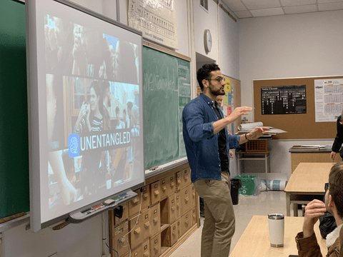 Shayan Majidy in front of a classroom of students teaching