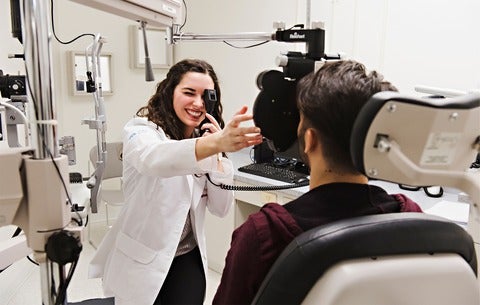 An ophthalmologist working with a patient