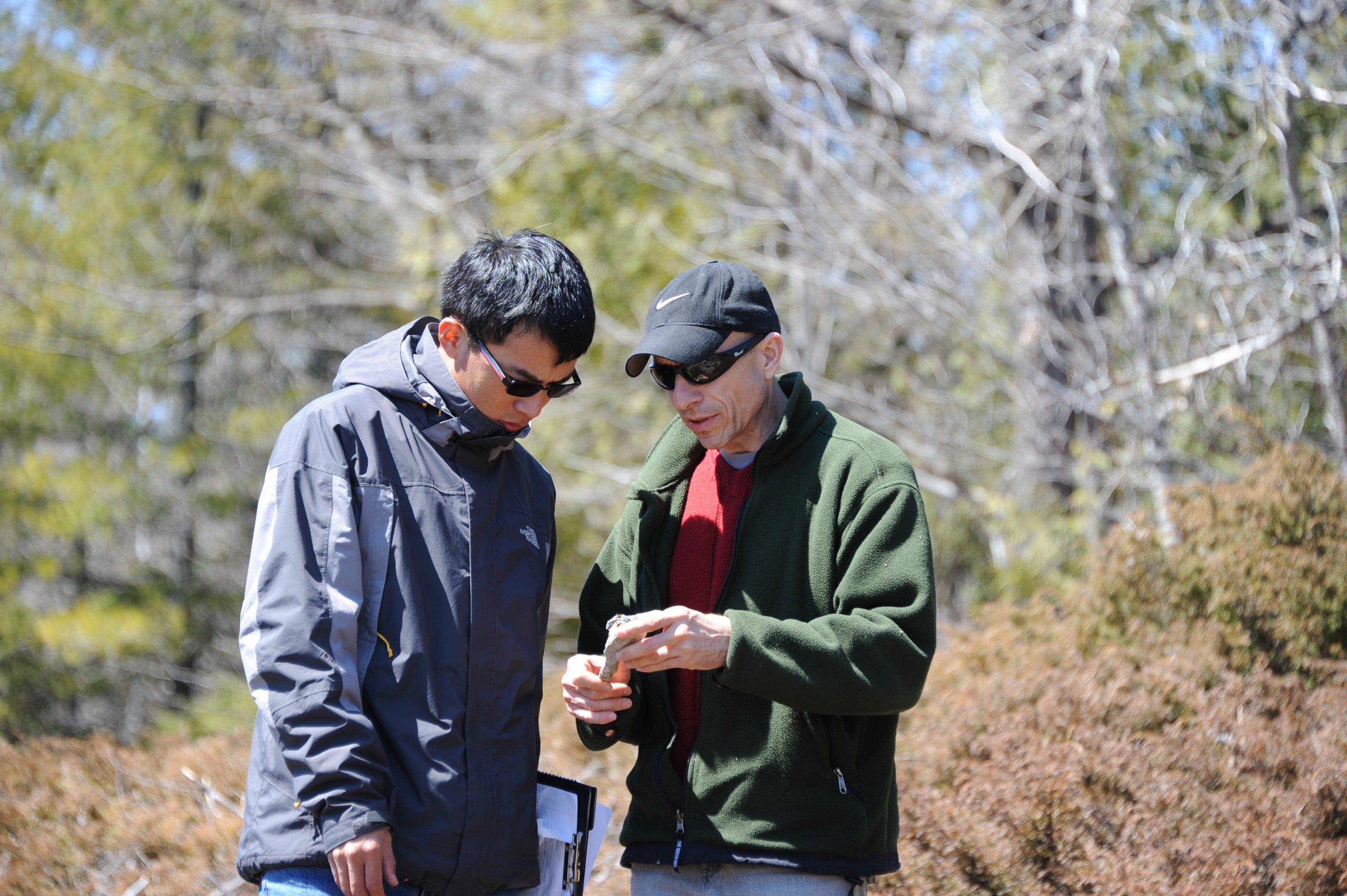 Mario Coniglio shows a student the features of a small rock.