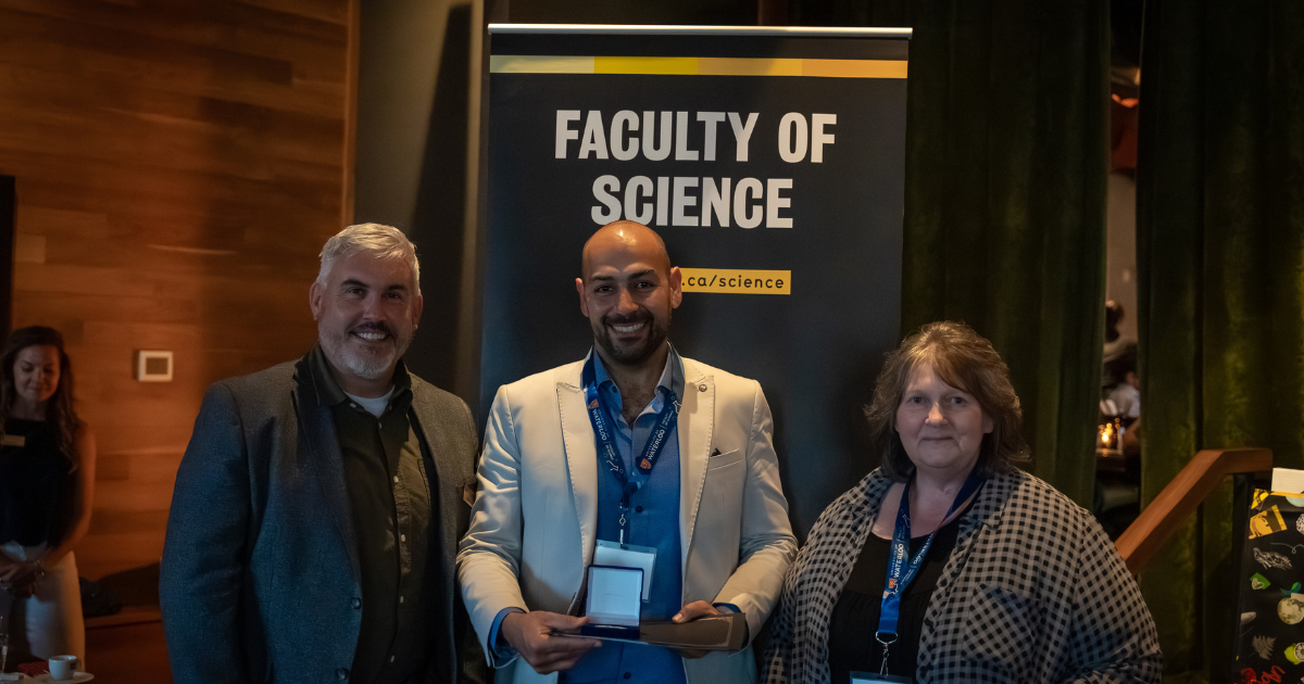 Science graduate student being presented a medal
