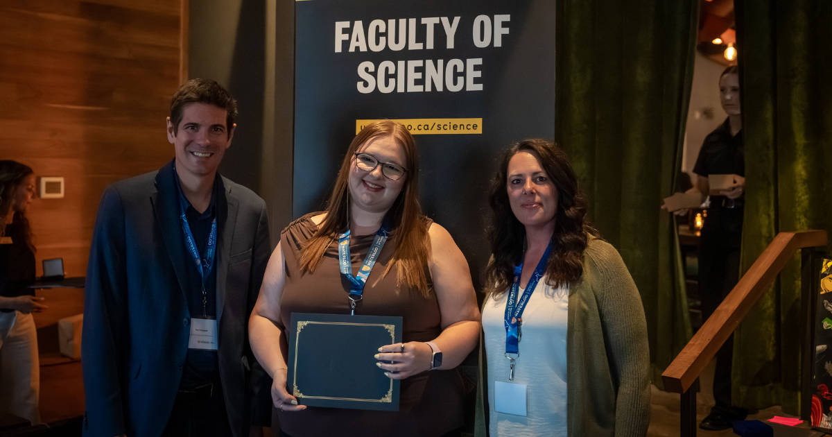 Science graduate student being presented an award