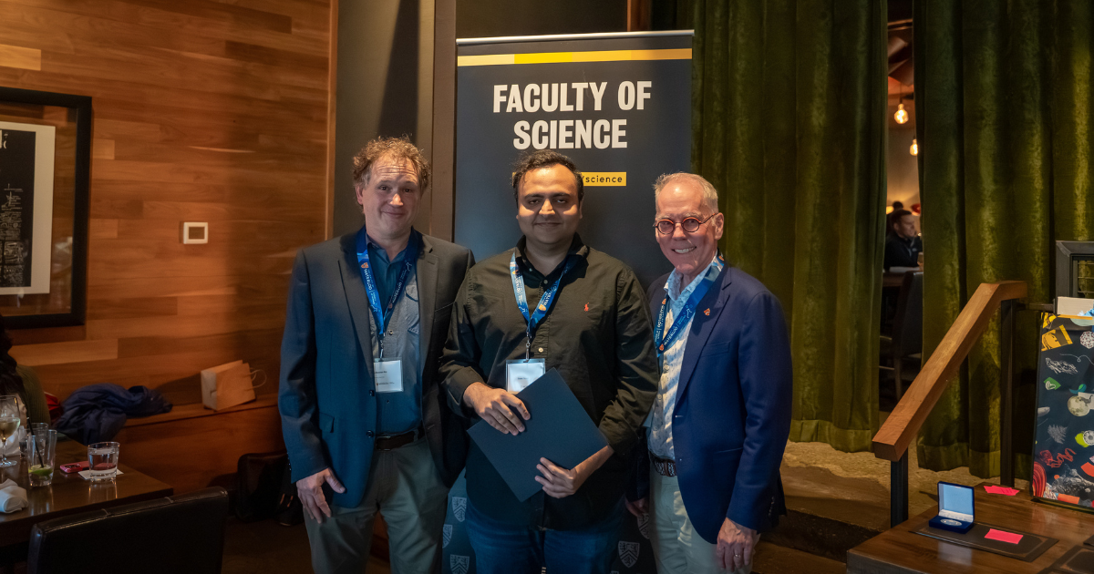 Science graduate student being presented an award