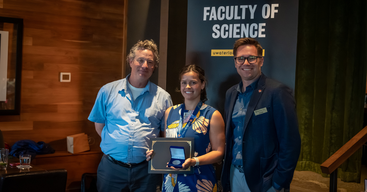 Science graduate student being presented an award