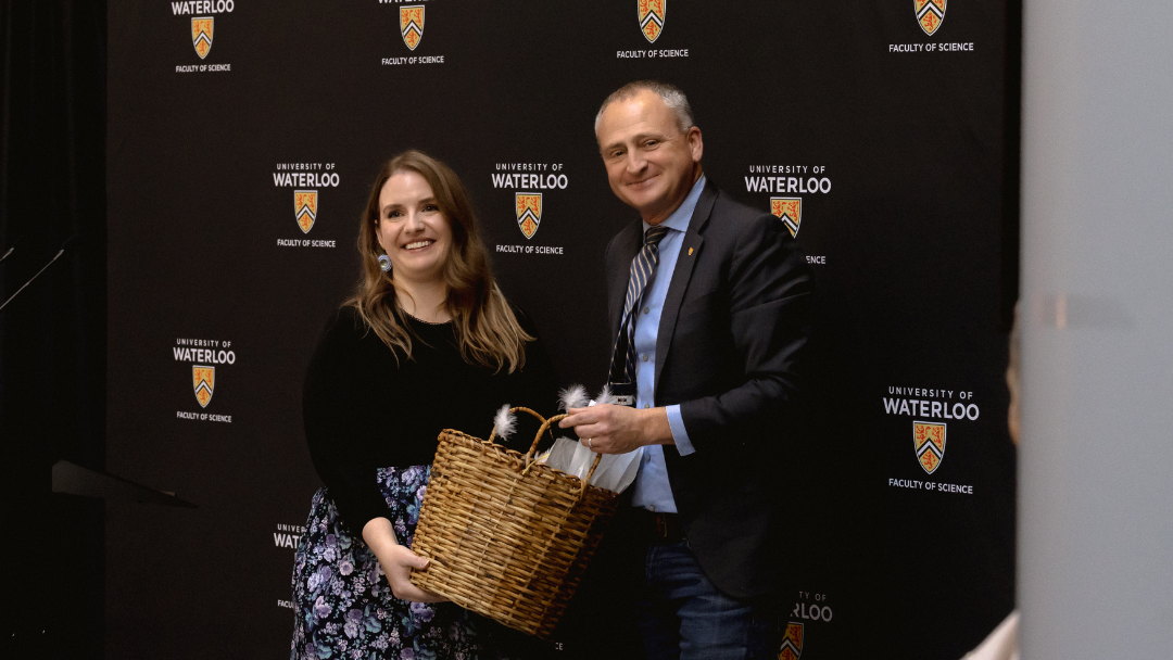 Dean Chris Houser presenting Savannah Sloat with a basket at the opening of the Science Indigenous Office.