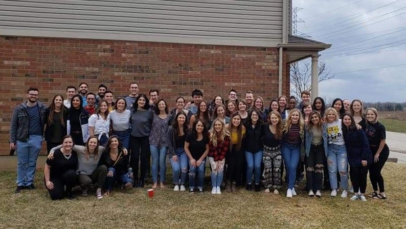 Group photo of Optometry Class 2020 outside a home